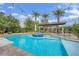 Beautiful pool and spa complemented by a cabana with a fireplace and seating area at 2208 Point Rock Ln, Las Vegas, NV 89134