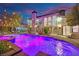Stunning pool area with colorful lighting, a covered patio, and comfortable seating, perfect for relaxation at 2208 Point Rock Ln, Las Vegas, NV 89134
