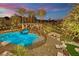 Beautiful backyard pool area with palm trees, string lights, a fire pit, and comfortable seating at 2208 Point Rock Ln, Las Vegas, NV 89134