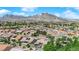 An aerial of a residential area, with mountain views, well-kept houses, and mature trees at 2232 Beacon Ridge Dr, Las Vegas, NV 89134