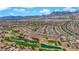 Wide aerial shot of a well-planned community with a golf course and desert mountains at 2232 Beacon Ridge Dr, Las Vegas, NV 89134