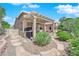 Beautiful backyard featuring a covered patio, built-in grill, and lush landscaping at 2232 Beacon Ridge Dr, Las Vegas, NV 89134
