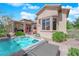 Inviting backyard showcases a hot tub, covered patio, and lush desert landscaping at 2232 Beacon Ridge Dr, Las Vegas, NV 89134