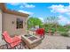 Cozy backyard features a stone fire pit with seating, a hot tub and mature landscaping at 2232 Beacon Ridge Dr, Las Vegas, NV 89134
