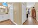 Elegant bathroom with double closets, white vanity, and wood look floors at 2232 Beacon Ridge Dr, Las Vegas, NV 89134