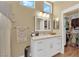 Bright bathroom featuring a walk-in closet, marble vanity, and neutral color palette at 2232 Beacon Ridge Dr, Las Vegas, NV 89134