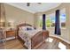 Cozy bedroom featuring a wooden bed frame and bright windows with outdoor views at 2232 Beacon Ridge Dr, Las Vegas, NV 89134
