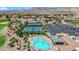 Aerial view of a community featuring a sparkling blue pool, spa, tennis courts, and well-maintained grounds at 2232 Beacon Ridge Dr, Las Vegas, NV 89134