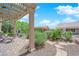 Inviting covered patio with stone column, outdoor seating area and well-kept landscaping at 2232 Beacon Ridge Dr, Las Vegas, NV 89134