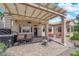 Charming backyard with covered patio, outdoor kitchen, and a stone-paved surface at 2232 Beacon Ridge Dr, Las Vegas, NV 89134