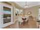 Inviting dining room featuring a wood table, upholstered chairs, and views of the outdoor patio at 2232 Beacon Ridge Dr, Las Vegas, NV 89134