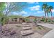 Inviting single-story home featuring stone accents, desert landscaping, and an attractive paved walkway at 2232 Beacon Ridge Dr, Las Vegas, NV 89134