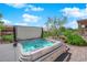 A luxurious hot tub with blue water, desert landscaping, and a covered patio in the backyard at 2232 Beacon Ridge Dr, Las Vegas, NV 89134