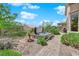 Backyard with a covered hot tub, lush desert landscaping, and a brick-paved walkway at 2232 Beacon Ridge Dr, Las Vegas, NV 89134