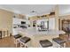 Open concept kitchen with white cabinets, stainless appliances, and an expansive marble island with seating at 2232 Beacon Ridge Dr, Las Vegas, NV 89134