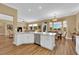 Bright, open-concept kitchen and dining area with wood floors and views of the backyard at 2232 Beacon Ridge Dr, Las Vegas, NV 89134