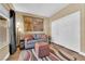 Comfortable living room with a sofa, ottoman, and tapestry wall hanging at 2232 Beacon Ridge Dr, Las Vegas, NV 89134