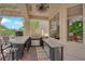 Outdoor kitchen with built-in grill, granite counter, and a bar stool seating area at 2232 Beacon Ridge Dr, Las Vegas, NV 89134