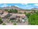 This backyard features a covered patio, spa, desert landscaping, and mountain views in the background at 2232 Beacon Ridge Dr, Las Vegas, NV 89134