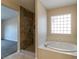Bathroom featuring a separate shower and bathtub with natural light at 2532 Bechamel Pl, Henderson, NV 89044