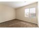 Bright bedroom features neutral paint, carpet, and a large window at 2532 Bechamel Pl, Henderson, NV 89044