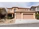 Two-story home featuring a tile roof, two-car garage, and desert landscaping at 2532 Bechamel Pl, Henderson, NV 89044