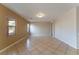 Open living room with tile floors and natural light from the windows at 2532 Bechamel Pl, Henderson, NV 89044
