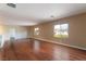 An open living room with hardwood floors and windows that offer views of the exterior at 2532 Bechamel Pl, Henderson, NV 89044