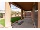 View of covered patio and backyard with artificial turf at 2532 Bechamel Pl, Henderson, NV 89044
