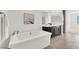 This bathroom features a soaking tub, double sinks and stylish tile flooring at 2555 Hampton Rd # 10104, Henderson, NV 89052