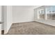 Bright bedroom featuring neutral carpeting, white walls, and natural light from the window at 2555 Hampton Rd # 10104, Henderson, NV 89052