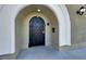 Unique front entrance featuring an arched doorway and ornamental iron gate at 2555 Hampton Rd # 10104, Henderson, NV 89052
