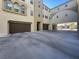 Modern home featuring multiple garages with concrete driveway, offering ample parking and easy access to the building at 2555 Hampton Rd # 10104, Henderson, NV 89052