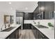Kitchen featuring stainless appliances, stylish dark cabinetry, quartz countertops, and modern fixtures at 2555 Hampton Rd # 10104, Henderson, NV 89052