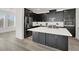 Modern kitchen boasts black cabinets, quartz countertops, stainless steel appliances and large island at 2555 Hampton Rd # 10104, Henderson, NV 89052