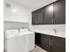 Functional laundry room with cabinets, sink, white quartz countertop, and appliances at 2555 Hampton Rd # 10104, Henderson, NV 89052