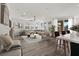 Bright, open living room with a large sectional sofa, neutral decor and wood flooring at 2555 Hampton Rd # 10104, Henderson, NV 89052