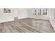 Empty living room with wood floors, large windows and lots of natural light at 2555 Hampton Rd # 10104, Henderson, NV 89052