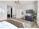 Spacious main bedroom featuring modern chandelier, plush carpet, ensuite bathroom access at 2555 Hampton Rd # 10104, Henderson, NV 89052