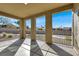 A covered patio with concrete flooring provides views of the backyard and desert landscaping at 2555 Hampton Rd # 10104, Henderson, NV 89052