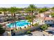 Community pool surrounded by palm trees, stone accents, and lounge chairs, perfect for relaxation and recreation at 2555 Hampton Rd # 10104, Henderson, NV 89052