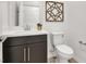 A stylish powder room with elegant fixtures, a toilet, and a dark vanity at 2555 Hampton Rd # 10104, Henderson, NV 89052
