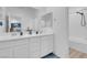 Modern bathroom with double vanity, mirrors, and shower with tub at 272 Mount Steele Ave, Henderson, NV 89015