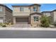 A well-maintained two-story home with a two-car garage, paved driveway, and desert landscaping at 272 Mount Steele Ave, Henderson, NV 89015