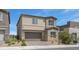 A two-story home featuring neutral stucco, a paved driveway leading to a two-car garage at 272 Mount Steele Ave, Henderson, NV 89015