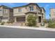 Charming two-story home featuring neutral stucco, a paved driveway and lush landscaping at 272 Mount Steele Ave, Henderson, NV 89015