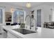 Modern kitchen with a large island, stainless steel sink, pendant lighting and modern fixtures at 272 Mount Steele Ave, Henderson, NV 89015