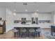 Well-lit kitchen featuring an oversized island with barstool seating, stainless steel appliances, and modern finishes at 272 Mount Steele Ave, Henderson, NV 89015