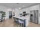 Stylish kitchen with a large island, seating, stainless steel appliances, and decorative lighting fixtures at 272 Mount Steele Ave, Henderson, NV 89015
