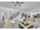 A bright open-concept floor plan with hardwood floors, a modern staircase, and a cozy seating area at 272 Mount Steele Ave, Henderson, NV 89015